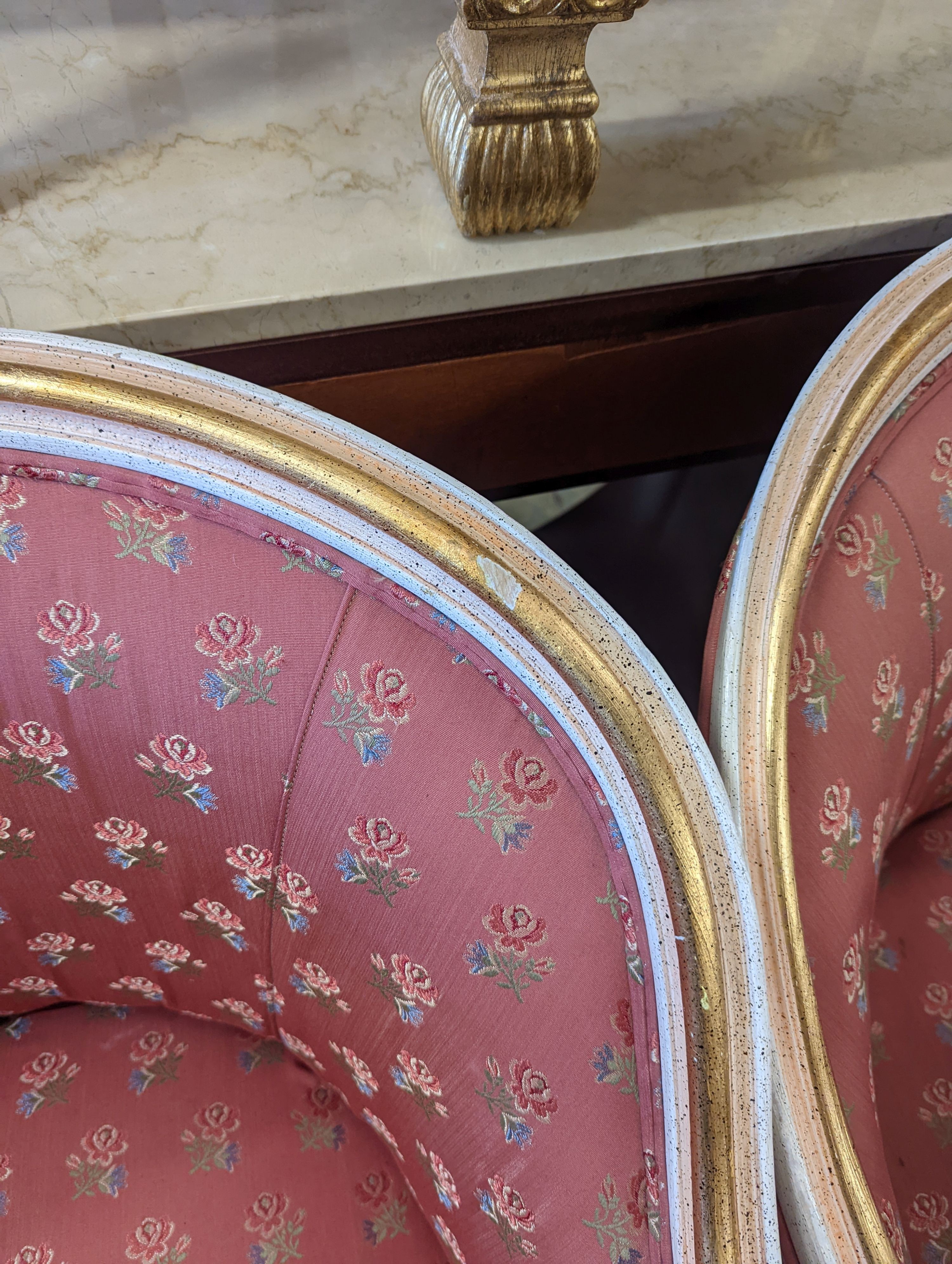A pair of Louis XVI design painted parcel gilt tub framed chairs, width 65cm, depth 45cm, height 81cm